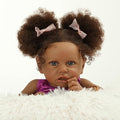 Reborn Baby Dolls Black Girl, 22" Realistic Baby Doll Lifelike African American Newborn Bebe Caramel Real Life Like Baby Dolls with Two Afro Puffs & Feeding Toys in Gift Box for Kids Age 3+